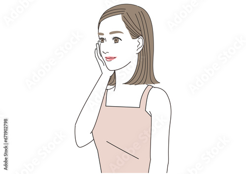 頬に手をあてて笑顔でまっすぐ前を見つめる女性