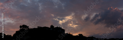 Colorful sunset over the Bulgarian town of Balchik. Cumulus clouds in a red-purple scale.