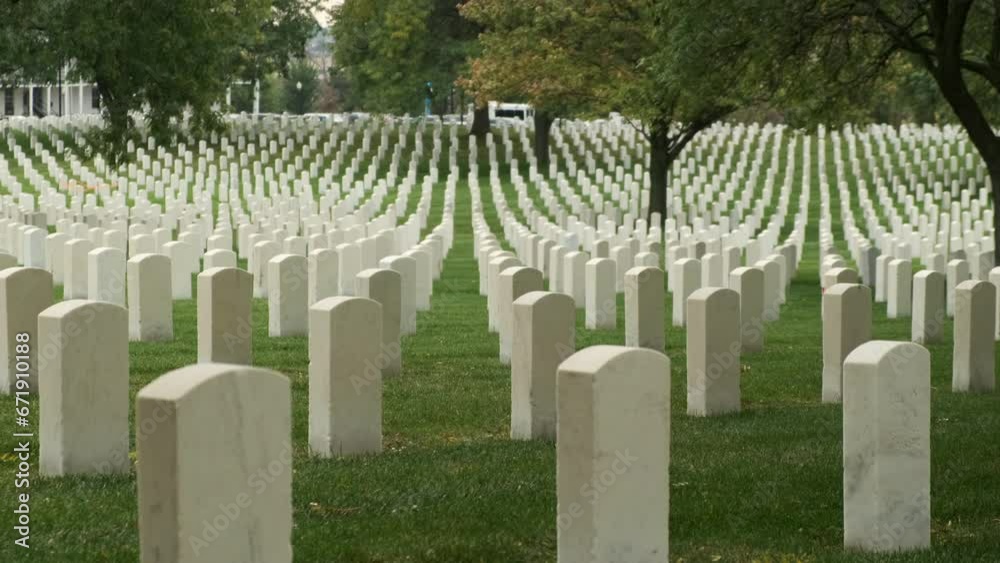 Field of American flags at Sunset. Flags on grave stones for memorial day remembrance at a cemetery. Small American flags and headstones at National cemetary- Memorial Day display. Field of American flags at Sunset. Flags on grave stones for memorial day remembrance at a cemetery. Small American flags and headstones at National cemetary- Memorial Day display.