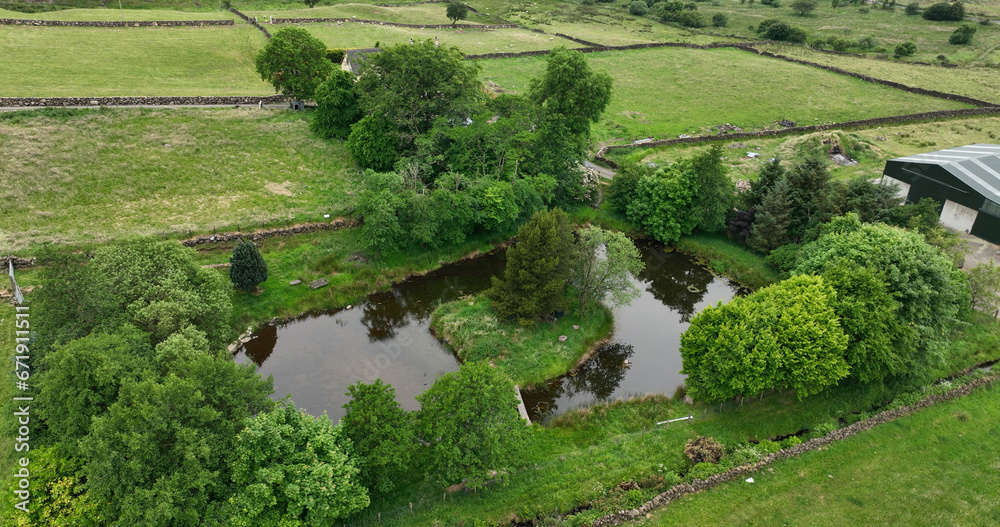 Aerial photo of a fishing pond in the UK countryside stalked with brown and Rainbow trout in a Conservation area