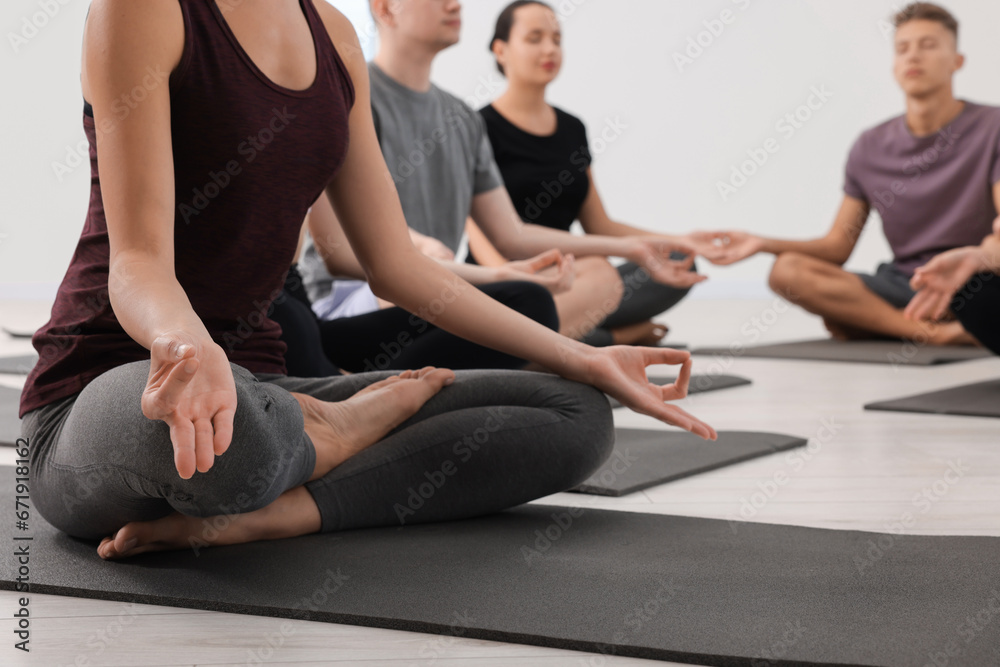 Group of people practicing yoga on mats indoors, closeup Group of people practicing yoga on mats indoors, closeup