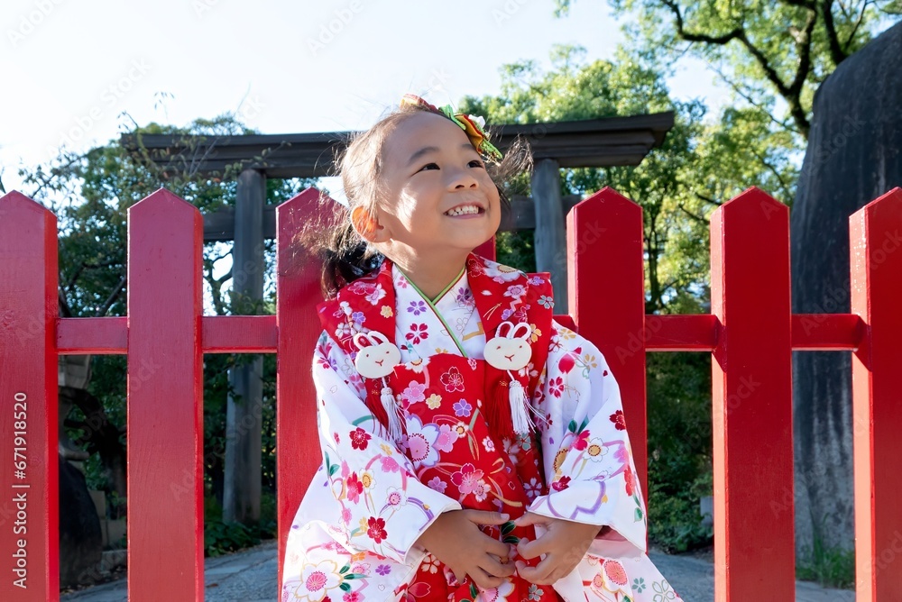 A happy toddler girl wearing red Japanese kimono A happy toddler girl wearing red Japanese kimono