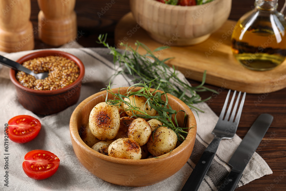 Delicious grilled potatoes with tarragon and mustard on wooden table