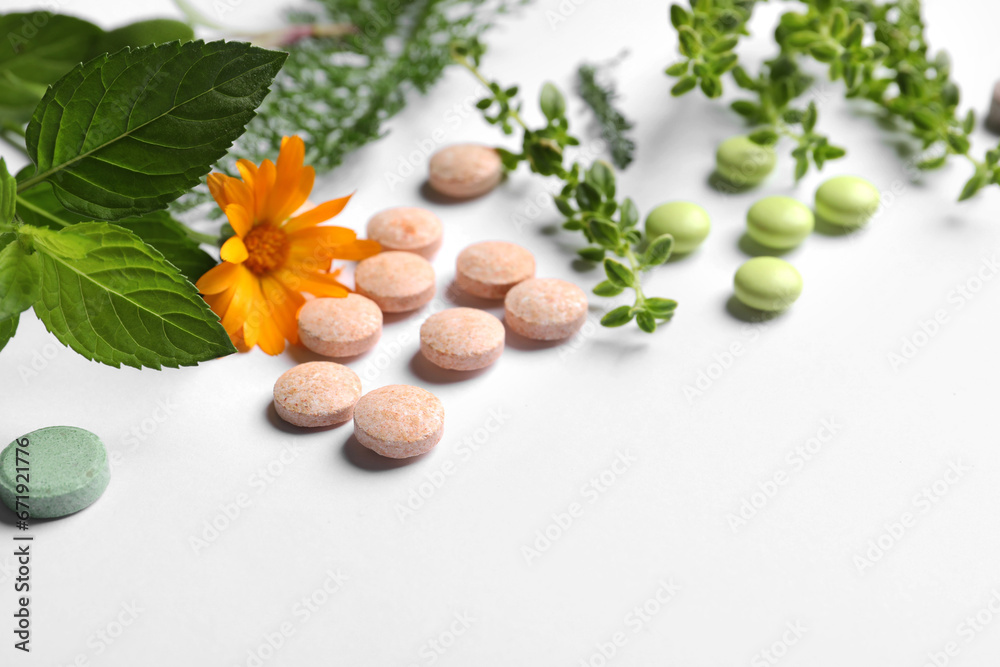 Different pills, herbs and flower on white background, closeup with space for text. Dietary supplements Different pills, herbs and flower on white background, closeup with space for text. Dietary supplements