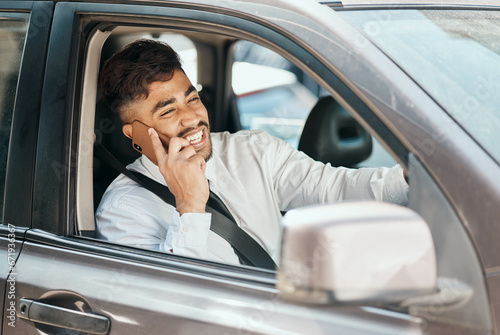 Happy business man, phone call and driving car for communication, mobile networking and chat in traffic. Indian male worker, driver and talking to contact, smartphone tech or travel in transportation © M Einero/peopleimages.com