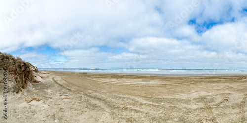 Ninety Mile Beach, New Zealand, with Tire Tracks Leading into the Endless Horizon of Northlands photo