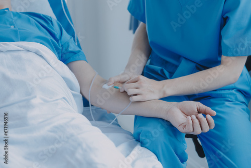 Injured patient showing doctor broken wrist and arm with bandage in hospital office or emergency room. Sprain, stress fracture or repetitive strain injury in hand. Nurse helping customer. First aid.