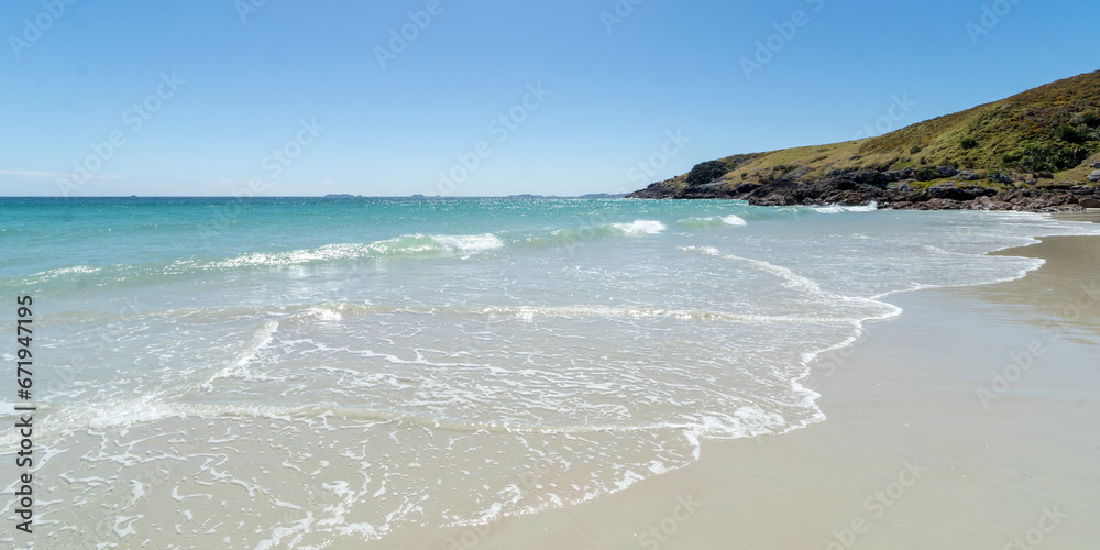 Puheke Beach with Crystal Clear Waters and White Sandy Shores with Coastal Rocks of Karikari Peninsula, Northland, New Zealand