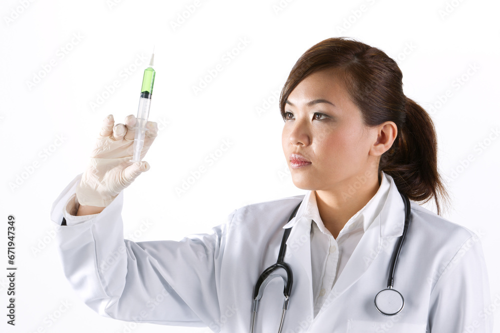 Portrait of a Female doctor holding a syringe. Portrait of a Female doctor holding a syringe.