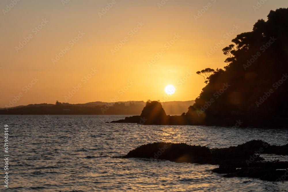 Golden Twilight: Blurred Sunset Background of Russell coastline and bots, Bay of Islands, New Zealand