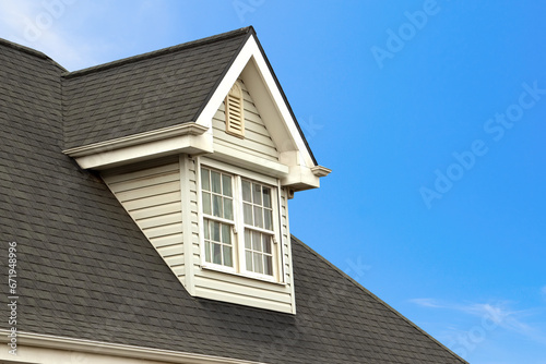 Charming House with Dormer in Clear Blue Sky photo