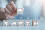 Insurance concept. Protection against a possible eventuality. House, Car, Family, Travel, Health with complete check mark and hand hold security icon cover by umbrella icon for life assurance concept.