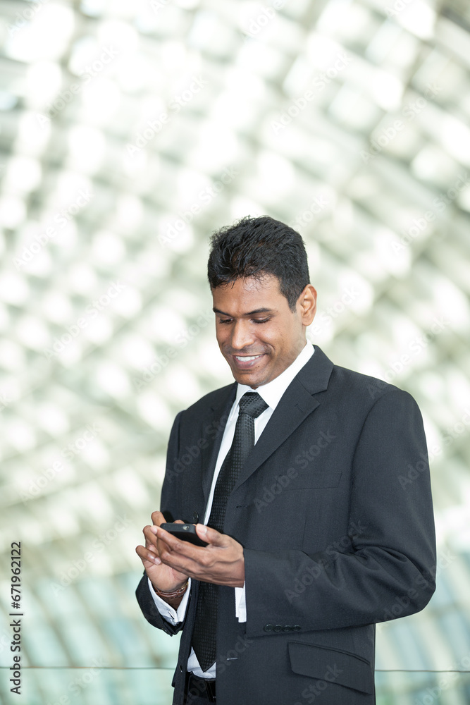 Indian business man using mobile phone. Indian business man using mobile phone.
