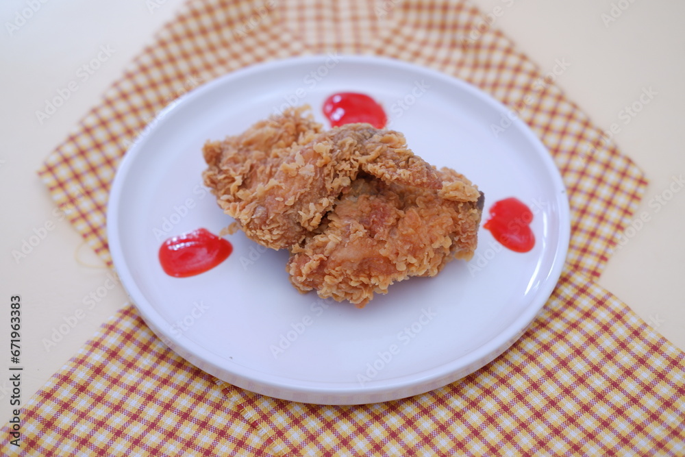 Crispy fried chicken on a plate with sauce, stock photo