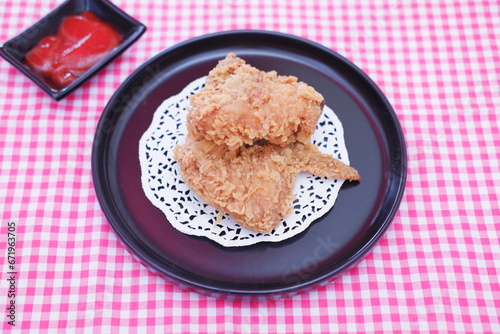 Crispy fried chicken on a plate with sauce, stock photo