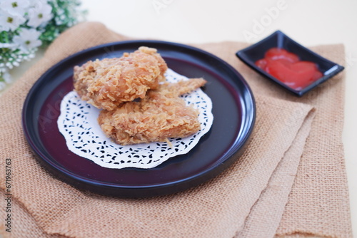 Crispy fried chicken on a plate with sauce, stock photo