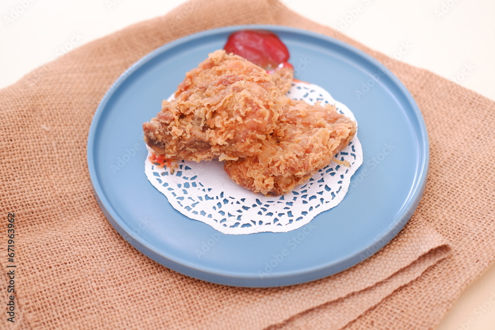 Crispy fried chicken on a plate with sauce, stock photo Crispy fried chicken on a plate with sauce, stock photo