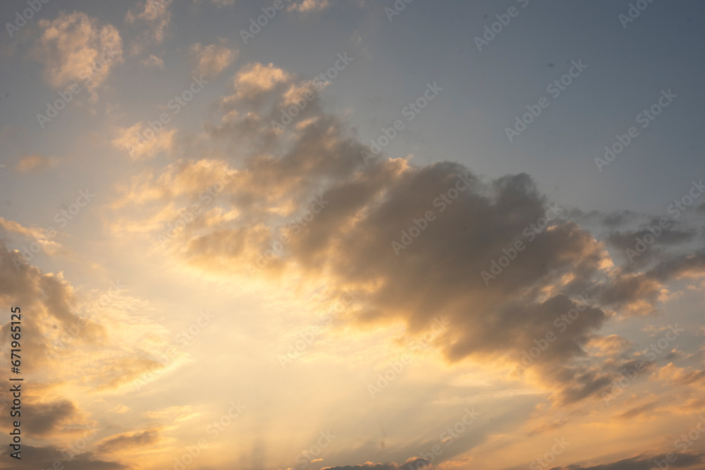 Obraz premium Sunset Sky on Twilight in the Evening with Orange Gold Sunset Cloud Nature Sky Backgrounds, Horizon Golden Sky, Sunrise clouds Gorgeous, Dusk sky