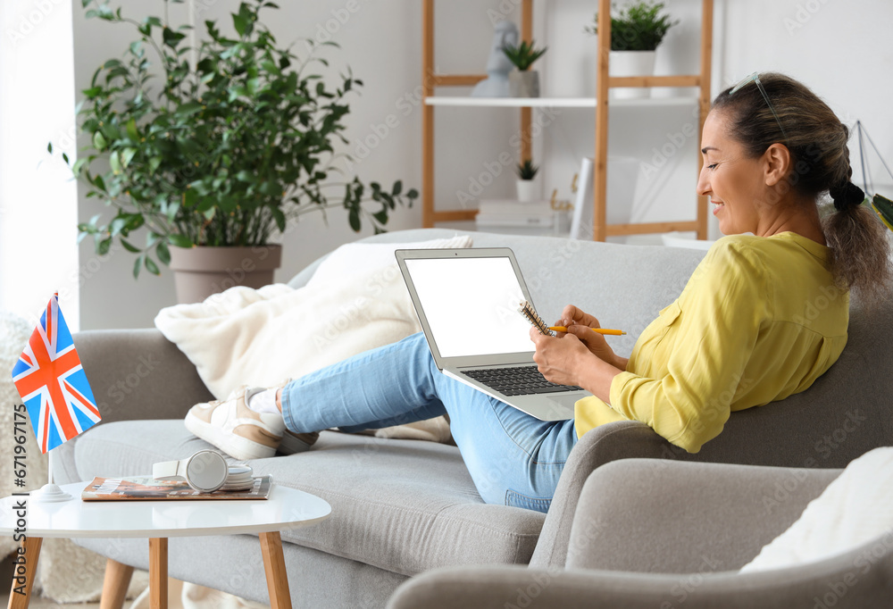 Mature woman with laptop studying English online at home Mature woman with laptop studying English online at home