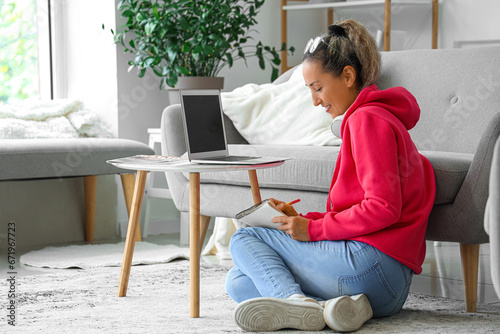 Mature woman with laptop an...