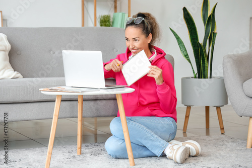 Mature woman with laptop an...
