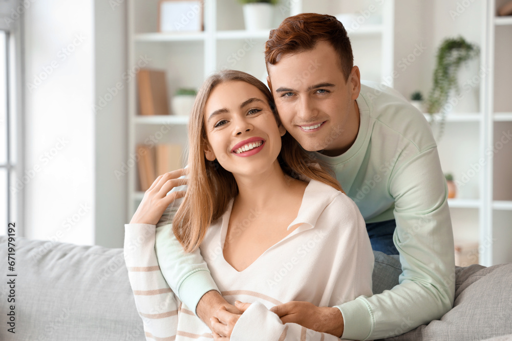Happy young couple hugging at home Happy young couple hugging at home