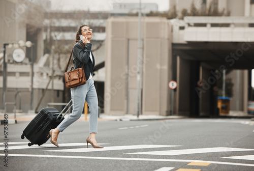 Business travel, phone call and happy woman with luggage in city street, networking or work trip. Smartphone, conversation and lady on road crosswalk with suitcase for traveling appointment in London