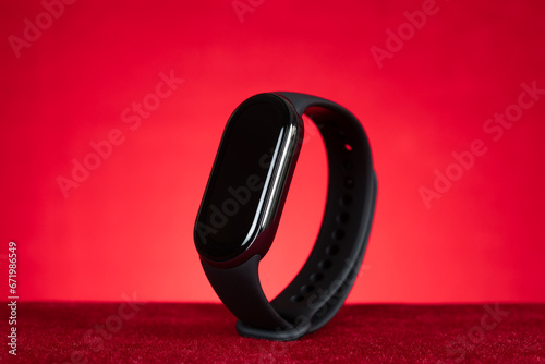 black smart bracelet on a red background