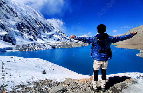 Man enjoying the view of Tilicho Lake in Manang Nepal. Tilicho Lake, the highest lake, Manang, Annapurna, Nepal, the Tilicho Lake is one of the highest lakes in the world. photo