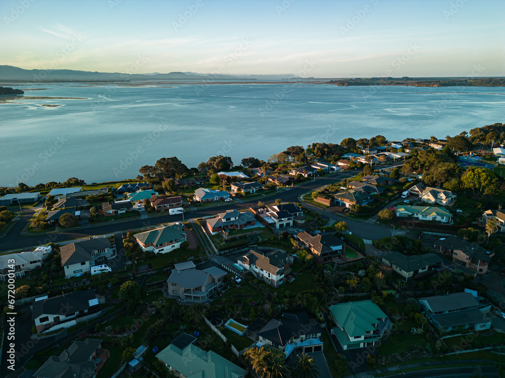 Aerial Sunset View of Houses Overlooking the Bay and Mount Manganui from Omokoroa, New Zealand