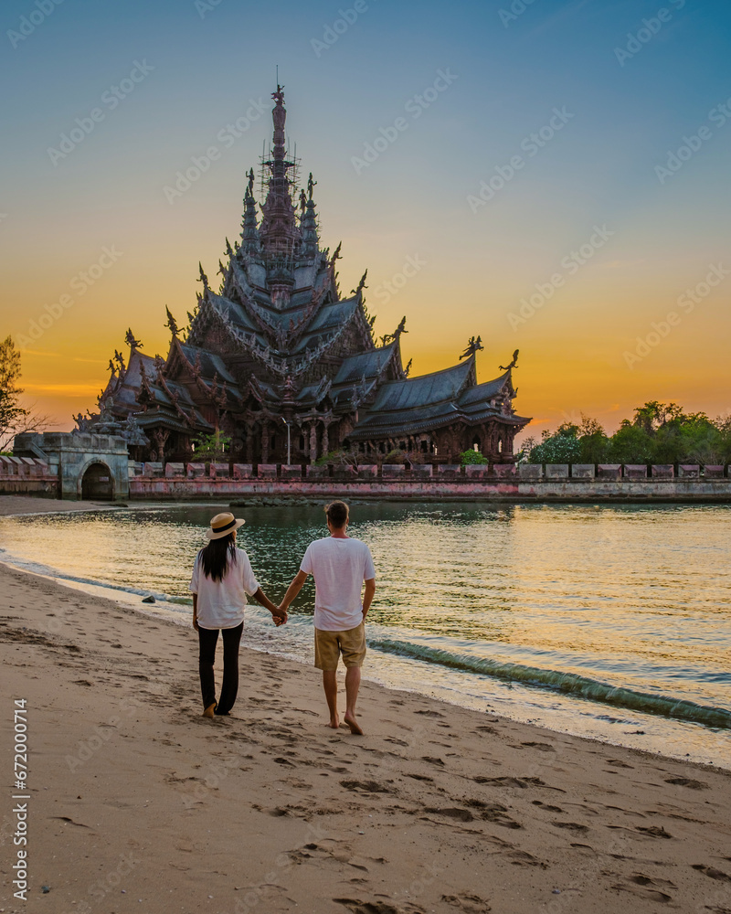 Sanctuary of Truth, Pattaya, Thailand, wooden temple by the ocean at sunset on the beach of Pattaya Sanctuary of Truth, Pattaya, Thailand, wooden temple by the ocean at sunset on the beach of Pattaya