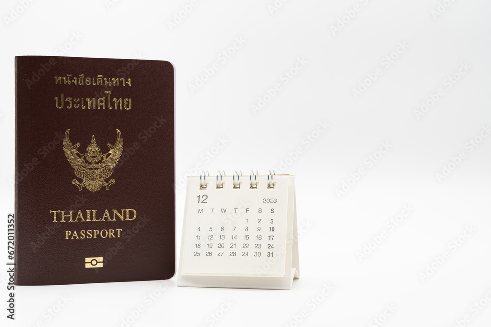 Simple desk calendar for December 2023 and Passport. Calendar and holiday concept with passport isolate on white background. Simple desk calendar for December 2023 and Passport. Calendar and holiday concept with passport isolate on white background.