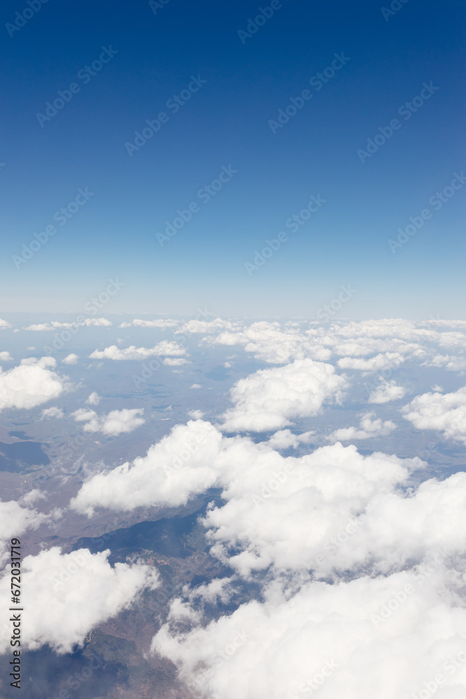 Beautiful view from the airplane window from above to the clouds, mountains, roads, rivers. Picturesque landscape from a helicopter window on a sunny day. Beautiful view from the airplane window from above to the clouds, mountains, roads, rivers. Picturesque landscape from a helicopter window on a sunny day.