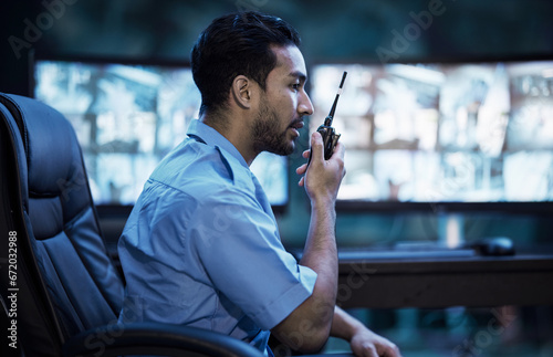 Security guard in control room, man with radio and screen to check cctv in virtual office for alarm. Safety, surveillance and agent, video to monitor crime and privacy for communication in protection