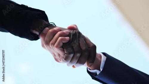 Llow angle shot of Black and White Businessmen Shaking Hands photo