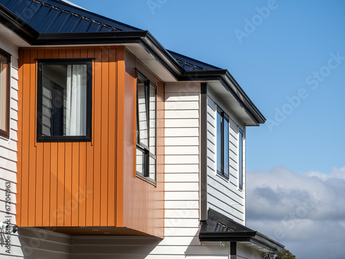 Brand new residential townhouse. Terraced houses. Blue sky in background.