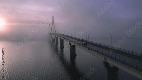 Car drives over bridge on the left side of the road, Heavenly Beautiful Morning Sunrise photo