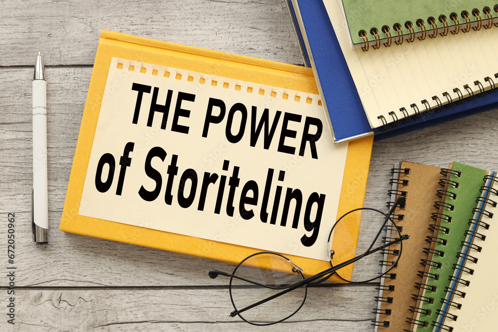 sheet of paper on a yellow notepad and glasses on the table. workbooks. text THE POWER OF STORYTELLING sheet of paper on a yellow notepad and glasses on the table. workbooks. text THE POWER OF STORYTELLING