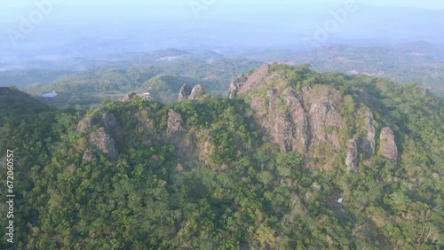 Aerial view of rock mountain overgrown by dense of forest. Prehistoric volcano of Nglanggeran, Yogyakarta, Indonesia photo