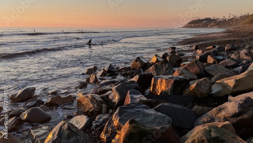 Southern California beach scenes with sunsets, surfers, tide pools and palms trees at Swamis Reef Surf Park Encinitas California.
