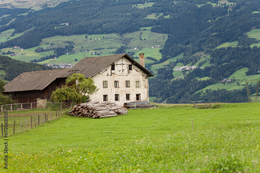 very old abandoned farm among a pasture in Val Gardena