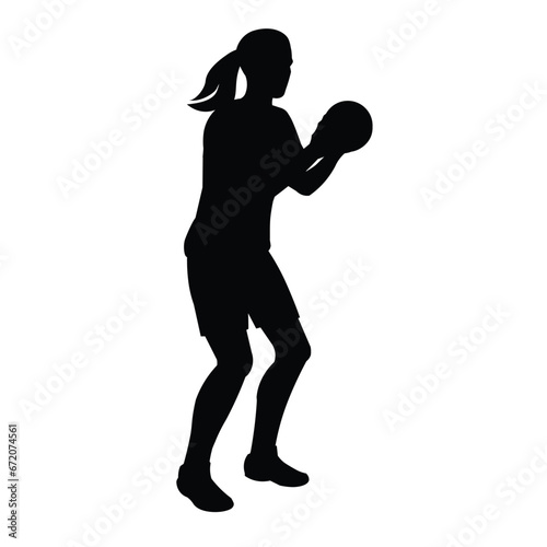 Black silhouette of a women's handball girl player with a ball in her hands standing in a half-turn to throw at the goal