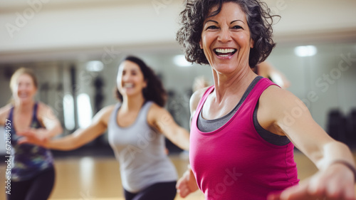Middle-aged women enjoying a joyful dance class, candidly expressing their active lifestyle. 