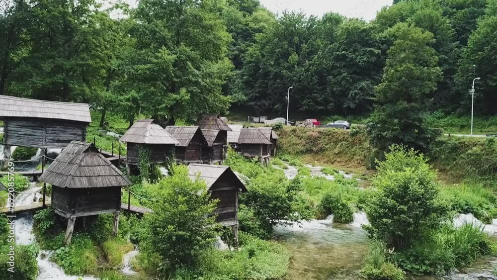 Watermills on small river near Jajce, Bosnia, streams and bridges, greenery, drone aerial Watermills on small river near Jajce, Bosnia, streams and bridges, greenery, drone aerial