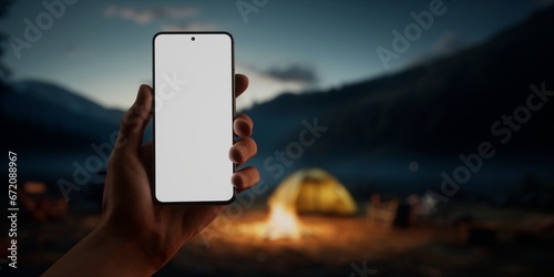 CU Caucasian male using his phone near campsite in the evening, screen mockup