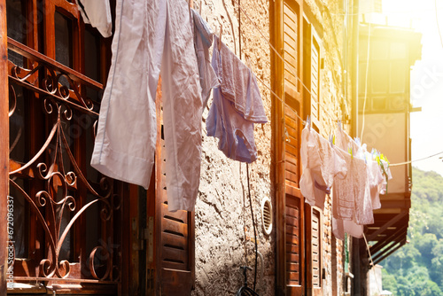 Picturesque narrow street with laundry hanging in Italy