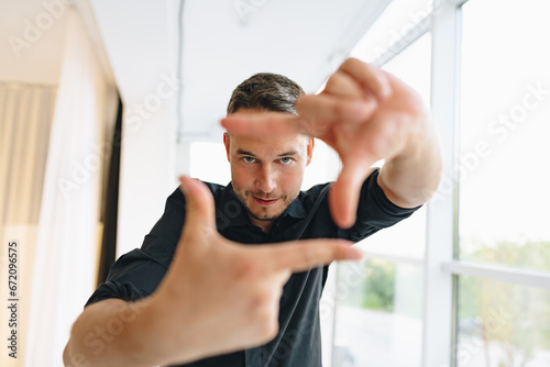 Portrait of a man in black shirt posing in photostudio