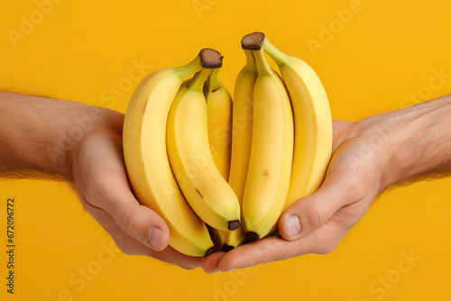 Bunch of bananas on hand in a holding bananas