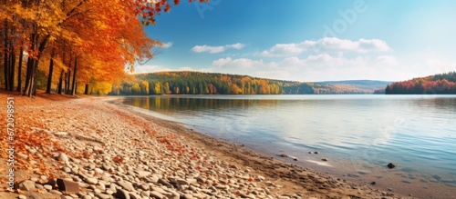Autumn in the Czech Republic brings a picturesque shore along Lipno Lake complete with a sandy beach