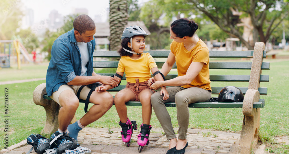 Fototapeta premium Family, rollerskate and interracial parents help kid with safety pads teaching her skating at the park and bonding outdoors. Mother, father and daughter learning to skate from mom and dad